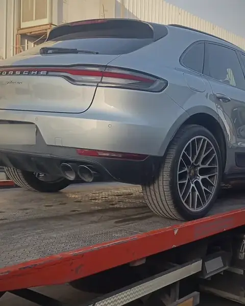 Flatbed transporting Porsche Macan