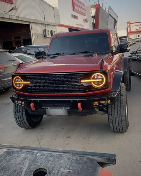 Flatbed transporting Ford Bronco